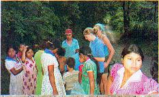 Lias and Christine help distribute food to the villagers