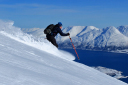 Dragon - Arctic Heights/Sgt Rob Brown skis powder above Lyngenfjord