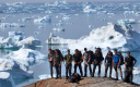Arctic Bugle/Exped members pose with the icebergs at Sermilik Fjord on Day 5